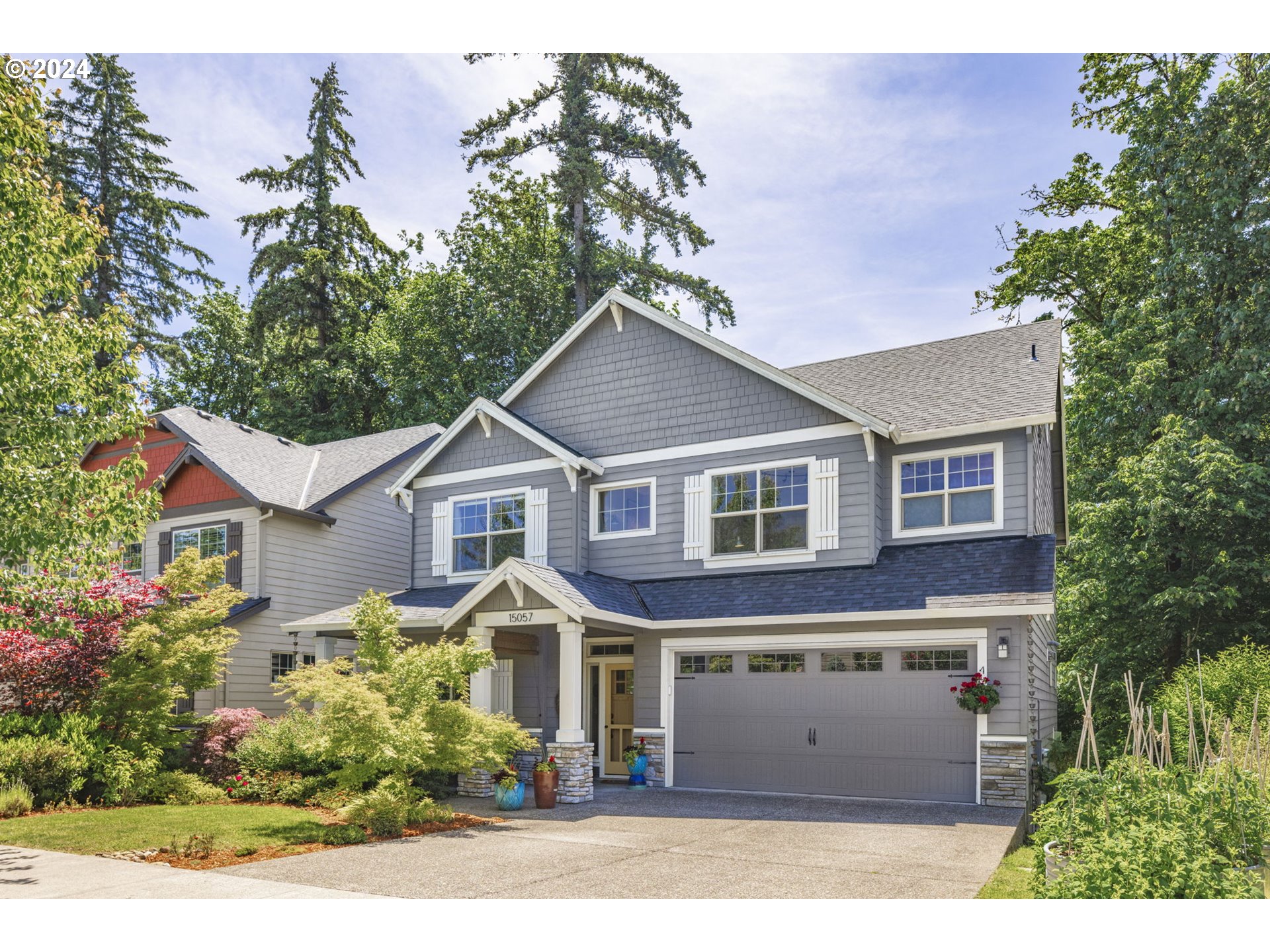 15057 Southeast Glenbrook Road Happy Valley, OR 97015 - Photo 42 of 43 a front view of a house with a yard and garage