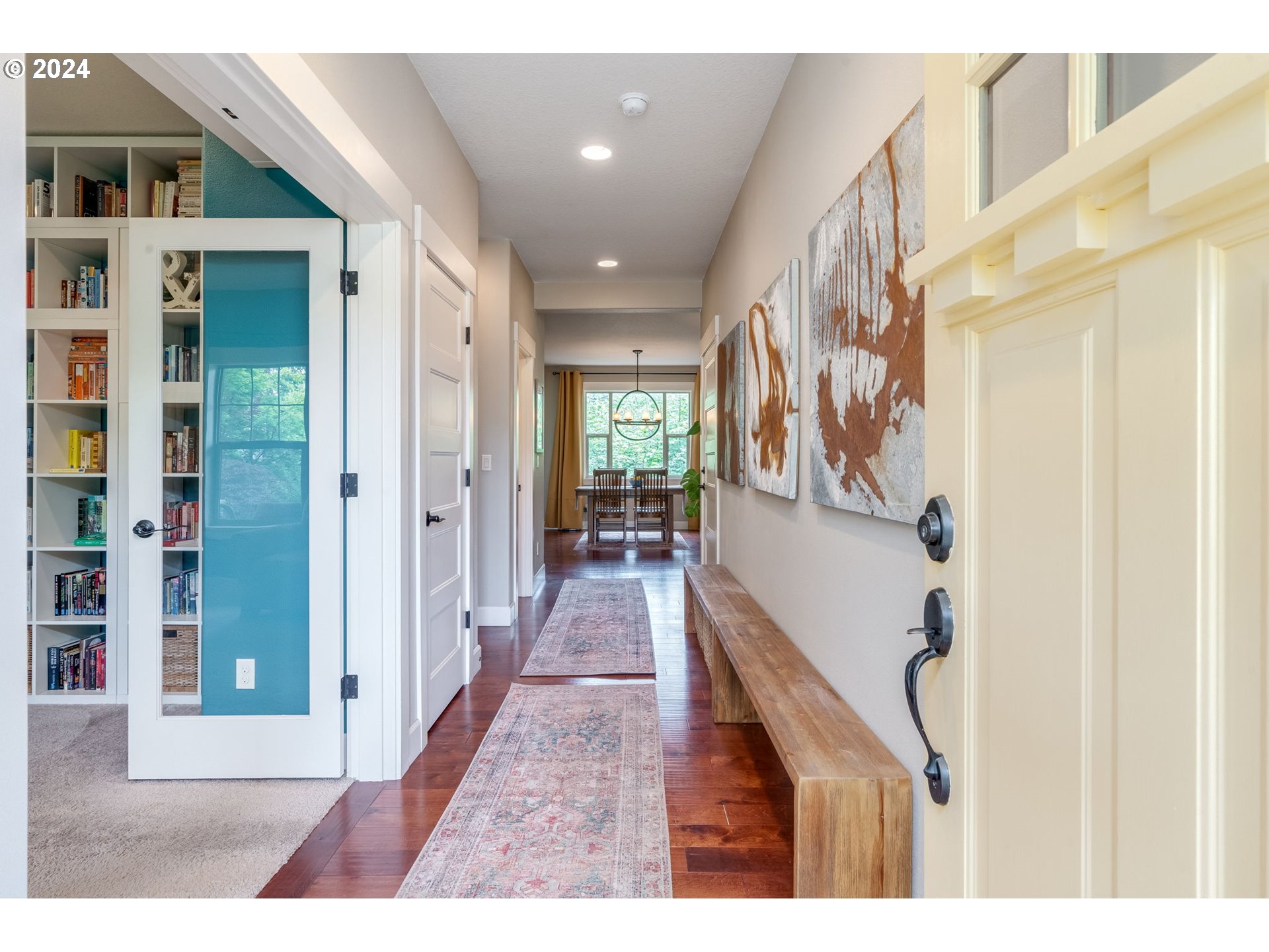 15057 Southeast Glenbrook Road Happy Valley, OR 97015 - Photo 6 of 43 a view of a hallway with wooden floor and staircase