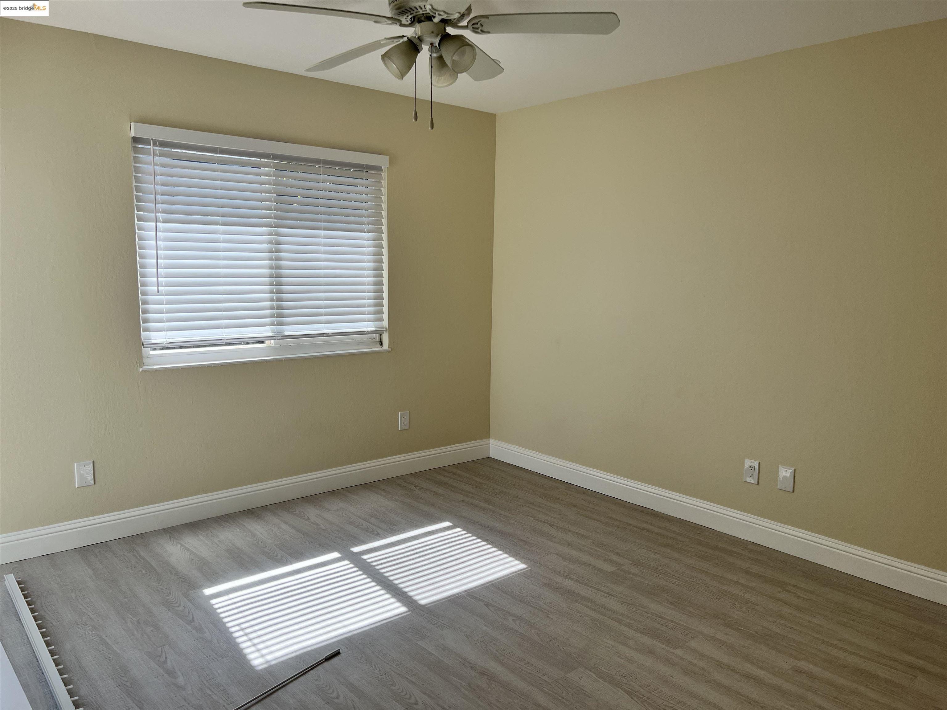 162 Riverside Drive Bay Point, CA 94565 - Photo 14 of 16 an empty room with wooden floor and windows