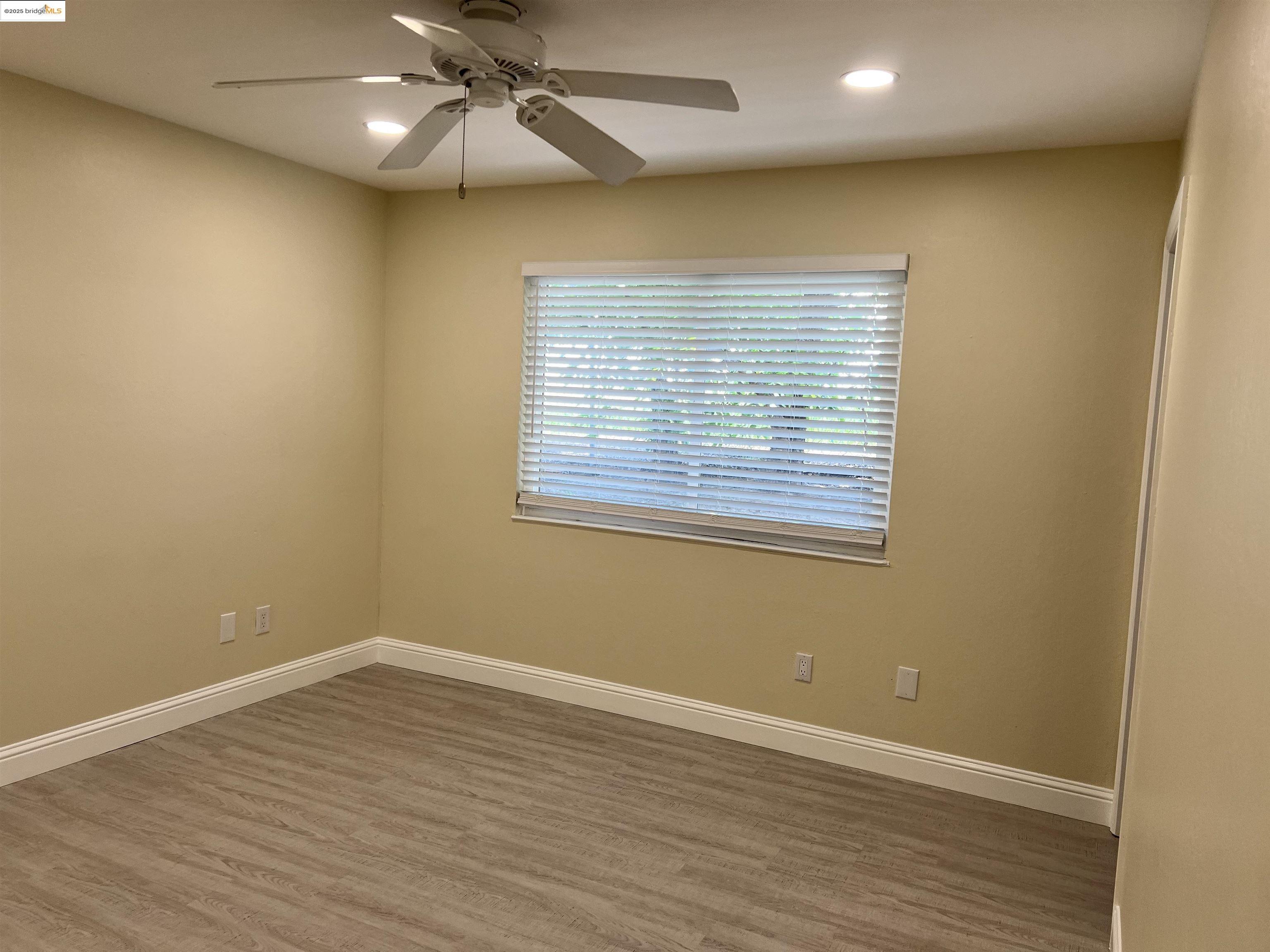 162 Riverside Drive Bay Point, CA 94565 - Photo 8 of 16 an empty room with wooden floor and windows