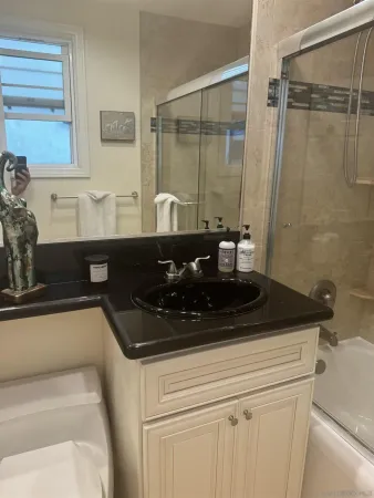 a picture of a bathroom with a shower