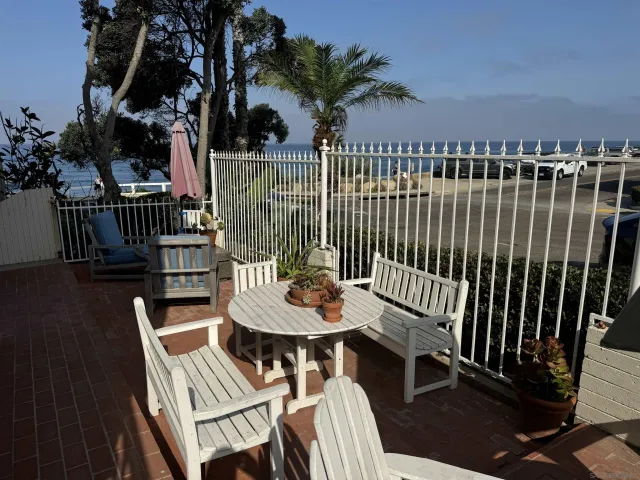a view of a balcony with furniture and wooden floor