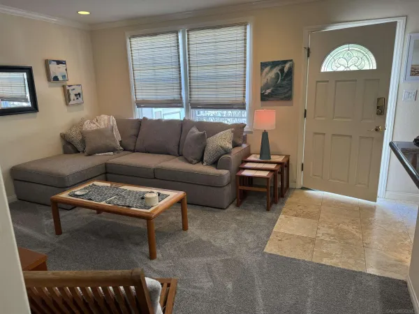 a living room with furniture a rug and a window