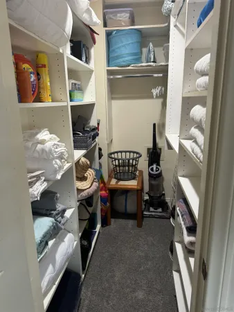 a bedroom with bed and a chandelier