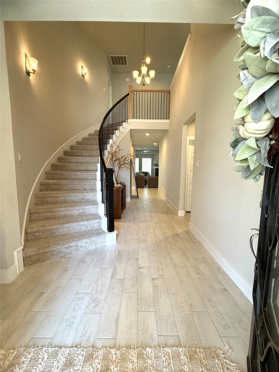 408 Hampton Edge Lane Waller, TX 77484 - Photo 5 of 16 a view of a hallway with a chandelier
