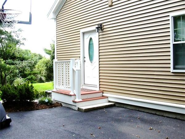 59 Gilman Road Waltham, MA 02452 - Photo 22 of 30 a view of a house with a yard and a garage