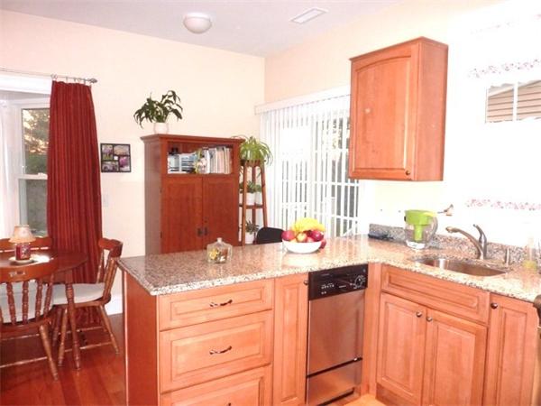 59 Gilman Road Waltham, MA 02452 - Photo 24 of 30 a kitchen with stainless steel appliances granite countertop a sink stove and cabinets