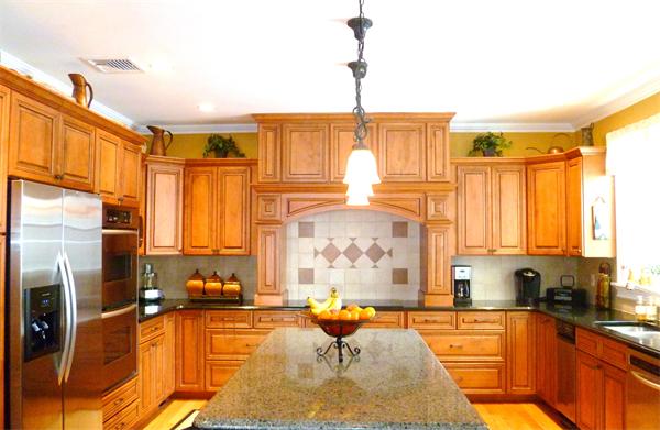 59 Gilman Road Waltham, MA 02452 - Photo 5 of 30 a living room with stainless steel appliances furniture a rug and a kitchen view
