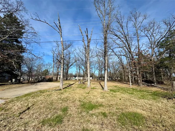 a backyard of apartments with large trees