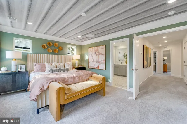 a spacious bedroom with a bed and glass door