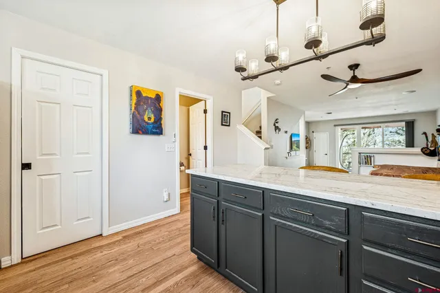 a view of a center island wooden floor and windows