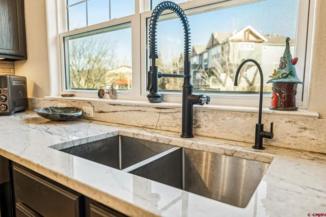 a view of a kitchen counter top a stove and a sink