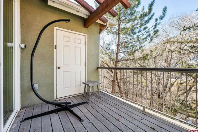 a view of a balcony with wooden floor and bench