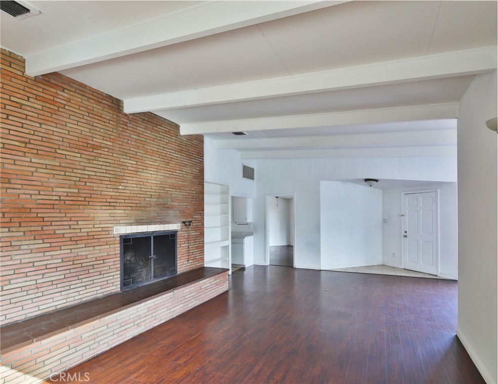 3060 Panorama Road Riverside, CA 92506 - Photo 28 of 38 a view of empty room with a fireplace and wooden floor