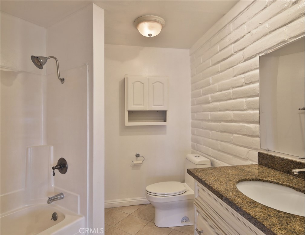3060 Panorama Road Riverside, CA 92506 - Photo 31 of 38 a bathroom with a granite countertop sink toilet and shower