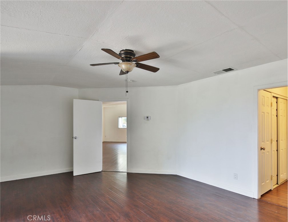 3060 Panorama Road Riverside, CA 92506 - Photo 32 of 38 a view of an empty room with wooden floor and a ceiling fan