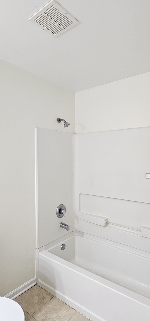 833 Village Quarter Road, Unit A3 West Dundee, IL 60118 - Photo 25 of 27 a bathroom with a bathtub and a shower