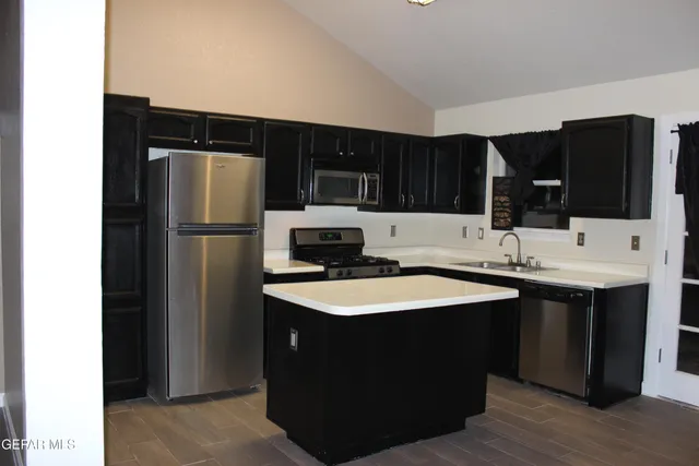 a view of an empty room with a fireplace and a window