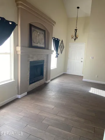 a kitchen with stainless steel appliances granite countertop a stove a refrigerator and a sink with wooden floors