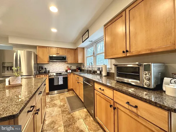 a kitchen with a dining table and chairs