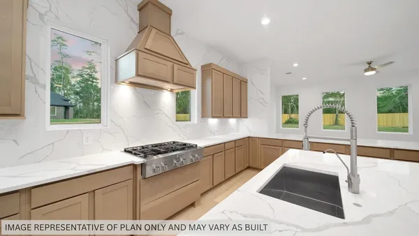 a kitchen with stainless steel appliances kitchen island granite countertop a sink and white cabinets