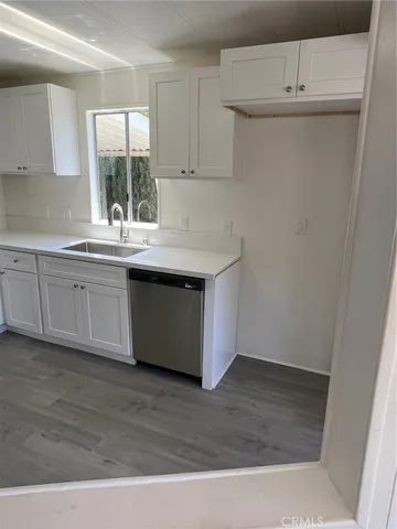 a kitchen with granite countertop a stove and a sink
