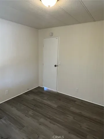 a view of wooden floor and windows in a room