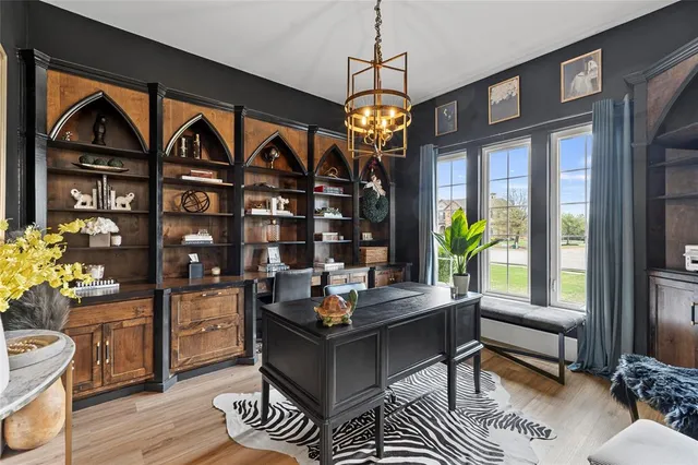 a living room with fireplace furniture and a chandelier