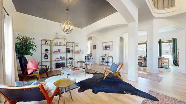 a living room with furniture or couch and a chandelier