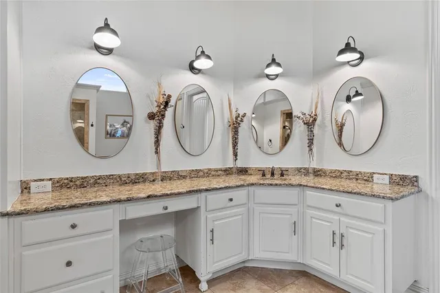 a spacious bathroom with a tub a double vanity sink and a mirror