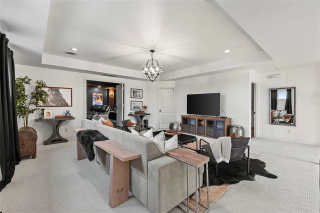 a living room with furniture and a chandelier