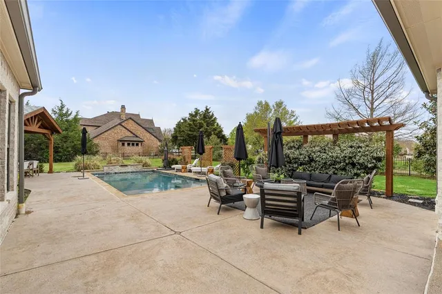 a view of a patio with a table chairs and a backyard