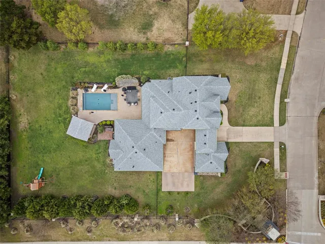 an aerial view of a house with a yard