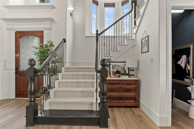 a view of staircase with wooden floor and a rug
