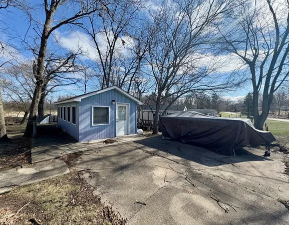 a view of backyard with wooden fence