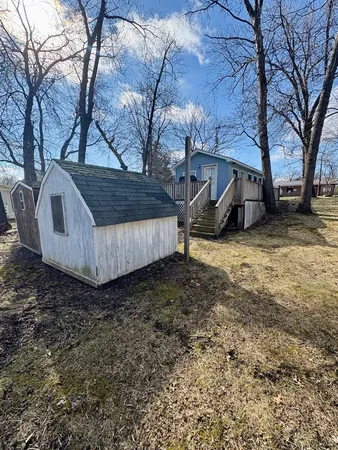 a view of a backyard with large tree