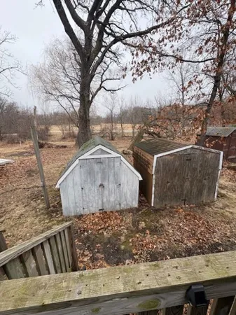 a view of backyard with wooden fence