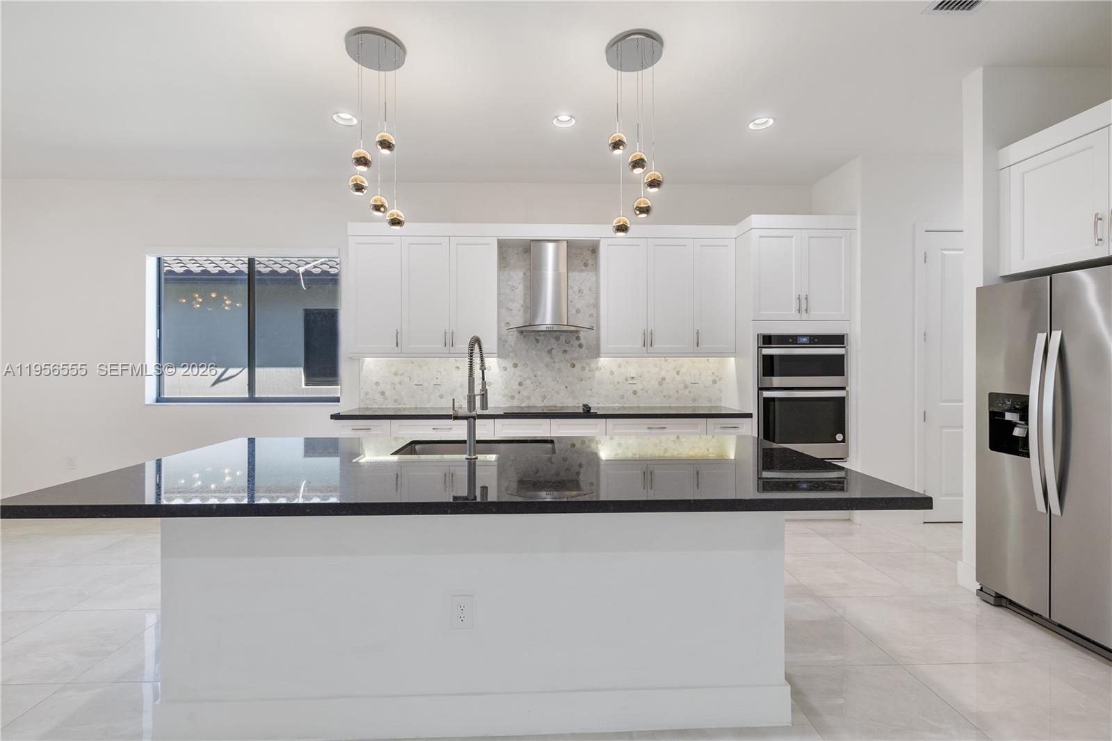 17665 Southwest 46th Street Miramar, FL 33029 - Photo 14 of 41 a large kitchen with kitchen island a sink stainless steel appliances and cabinets