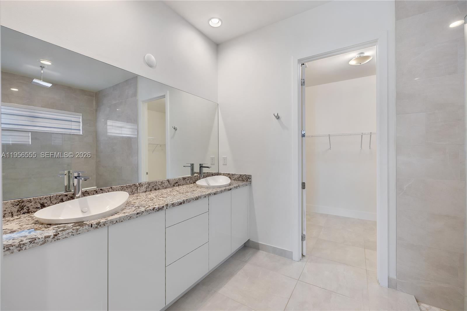 17665 Southwest 46th Street Miramar, FL 33029 - Photo 18 of 41 a bathroom with a granite countertop sink and a mirror