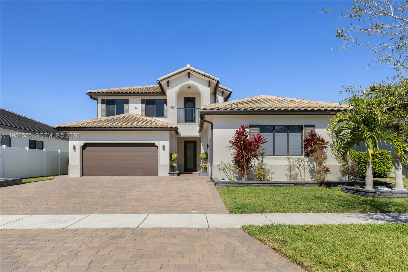 17665 Southwest 46th Street Miramar, FL 33029 - Photo 2 of 41 a front view of a house with a yard and garage