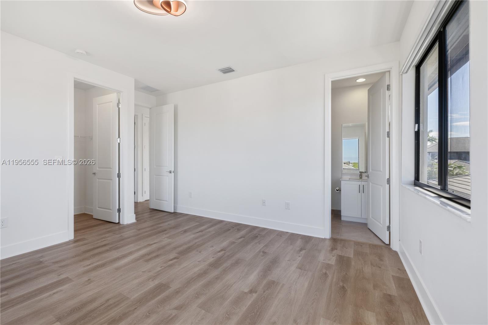 17665 Southwest 46th Street Miramar, FL 33029 - Photo 25 of 41 an empty room with wooden floor and windows