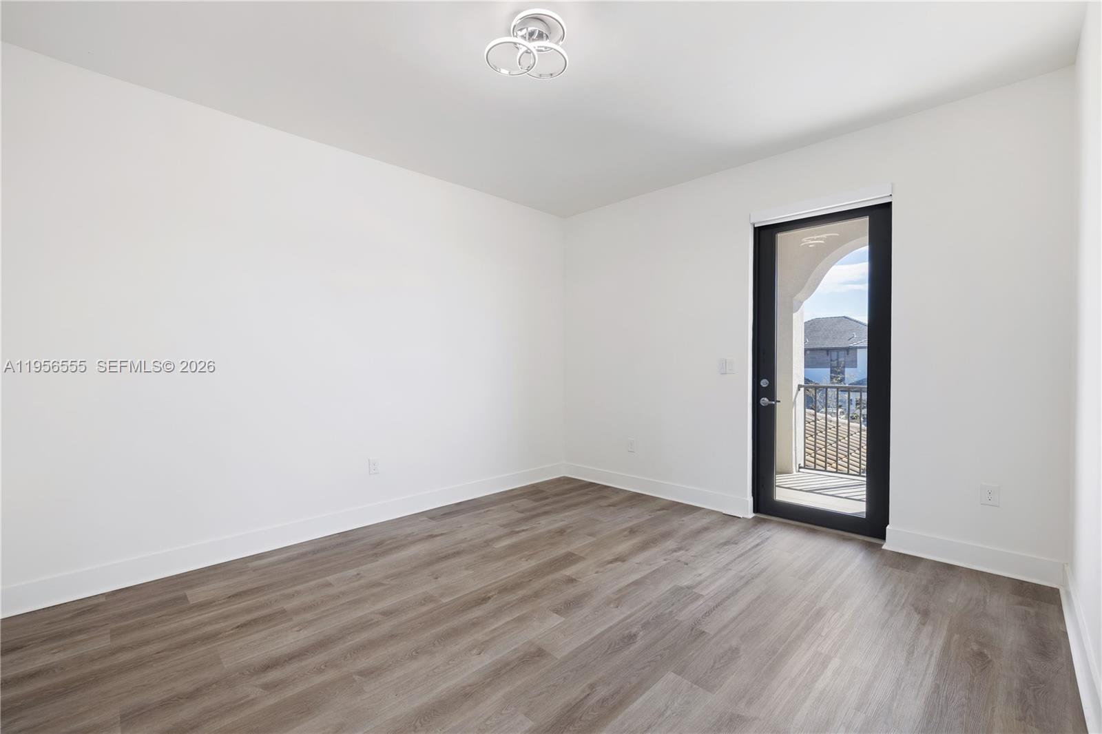 17665 Southwest 46th Street Miramar, FL 33029 - Photo 26 of 41 an empty room with wooden floor and mirror