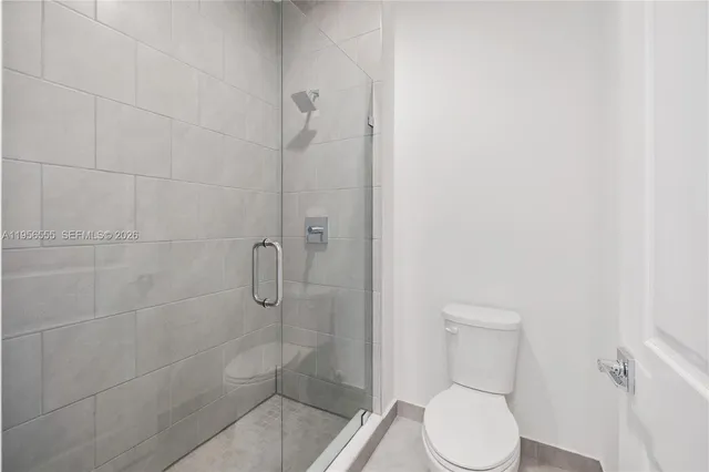 a white toilet sitting next to a bath tub
