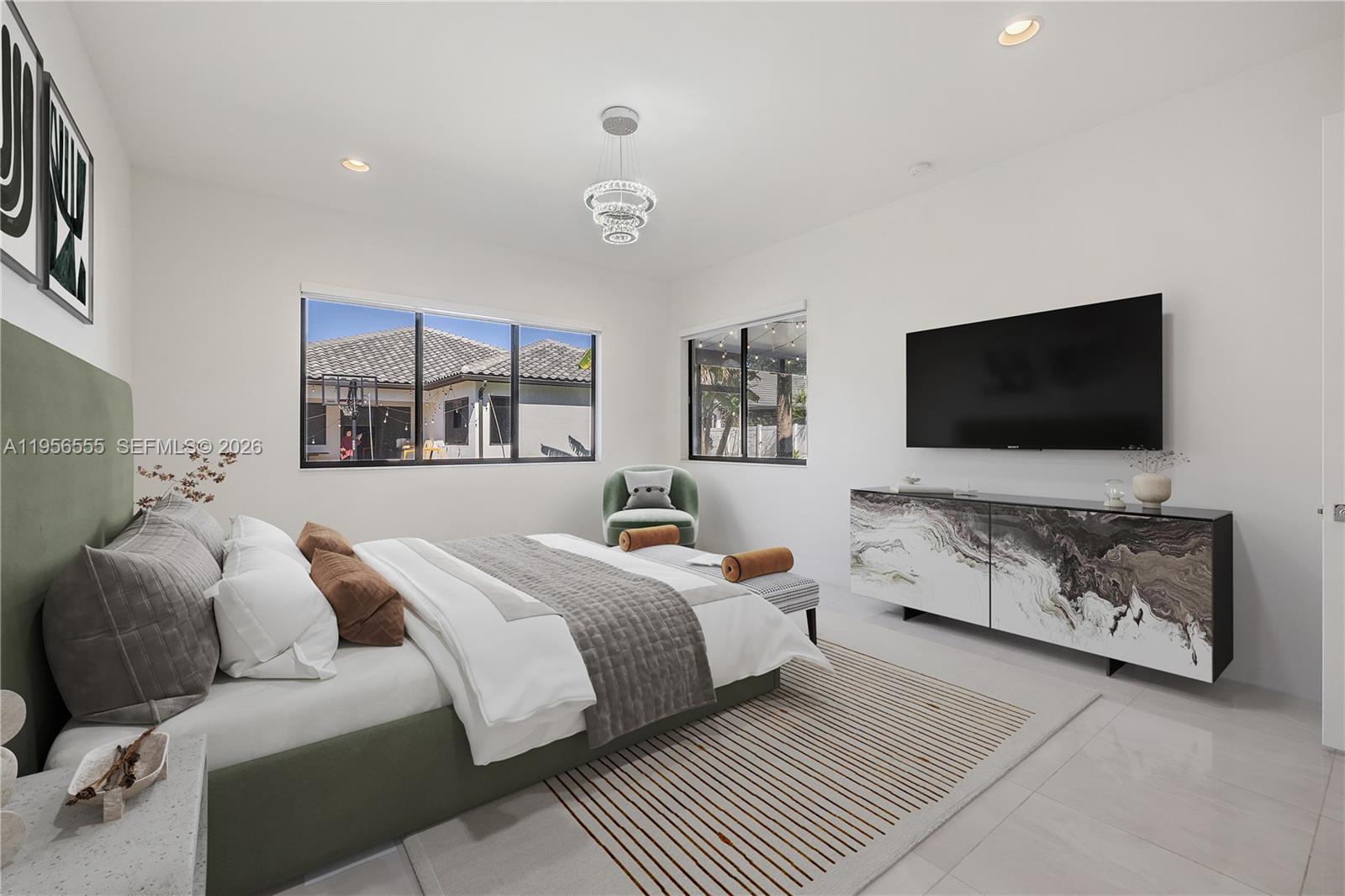 17665 Southwest 46th Street Miramar, FL 33029 - Photo 4 of 41 a bedroom with a bed and a flat screen tv