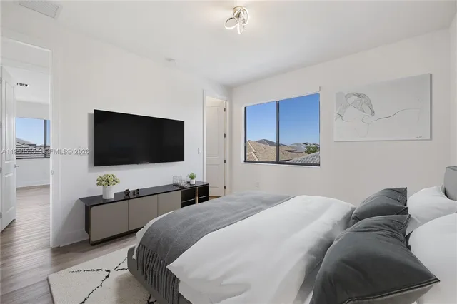 a bedroom with a bed and a flat screen tv