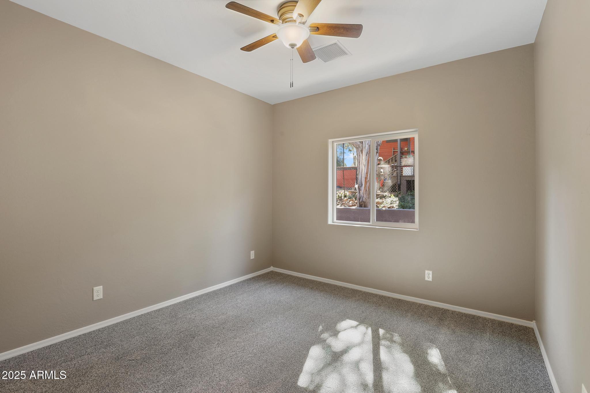 1019 South Ponderosa Street Payson, AZ 85541 - Photo 19 of 34 an empty room with a window and a fan
