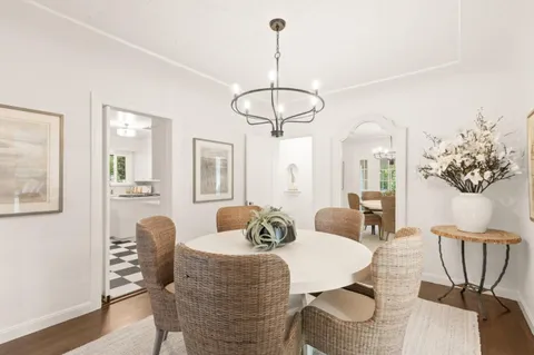 a dining room with furniture a livingroom and chandelier