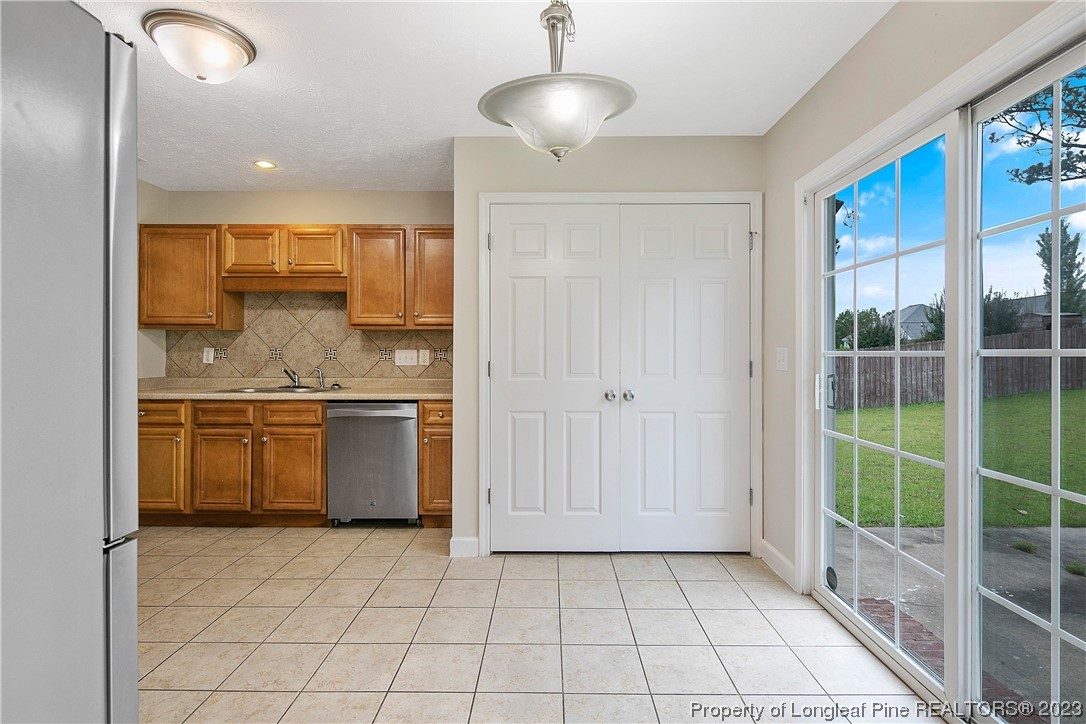 89 Rockingham Street Spring Lake, NC 28390 - Photo 11 of 41 a kitchen with a sink a counter top space cabinets and stainless steel appliances