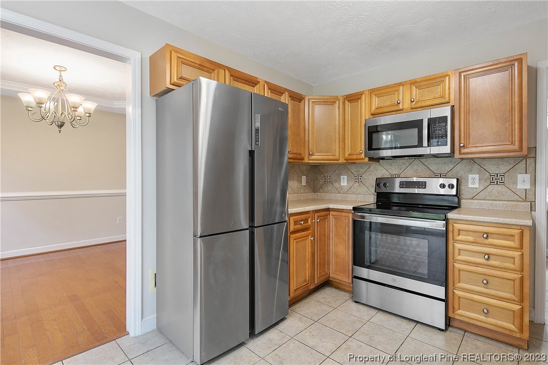 89 Rockingham Street Spring Lake, NC 28390 - Photo 14 of 41 a kitchen with granite countertop a refrigerator stove and microwave