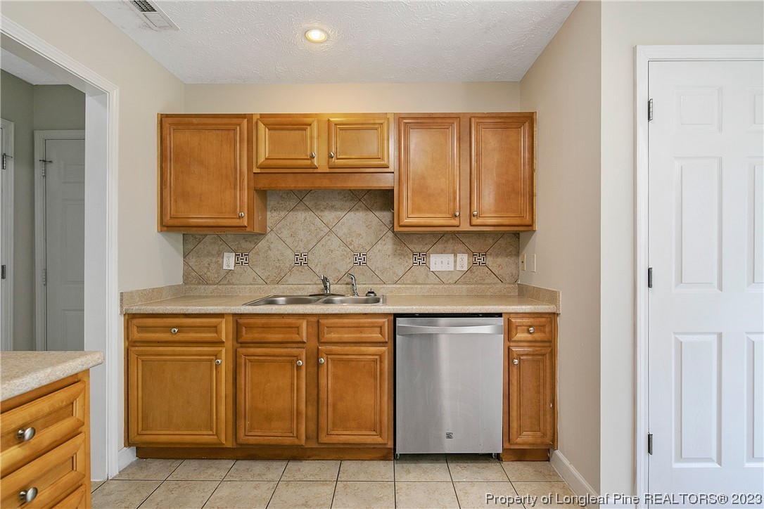 89 Rockingham Street Spring Lake, NC 28390 - Photo 17 of 41 a kitchen with stainless steel appliances granite countertop a sink and cabinets